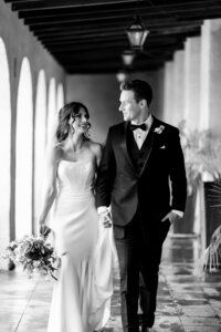 Wedding at the Royal Palms with Bride and Groom walking  in black and white