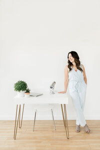 woman standing beside a desk