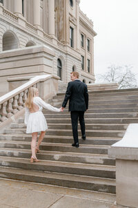 engaged couple on steps at Central high School downtown Omaha