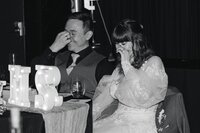 Couple walking through lush tropical greenery at greenhouse-style wedding venue – unique Colorado wedding photos