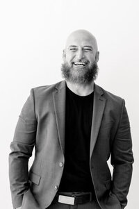 black and white photo of photographer smiling