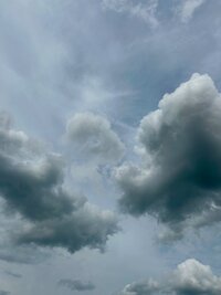 dark and light clouds facing eachother in the sky