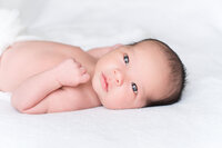 Newborn baby with eyes wide open looking at the camera