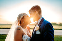lancaster ohio bride and groom wedding kiss in front of sunset
