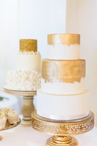 Two white and gold wedding cakes in North Carolina.