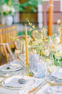 white and light blue table cloth with gold and light blue candles
