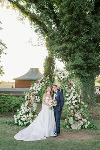 Joyful Bride and groom celebrating across the lawn at Hamilton Farm Golf Club in New Jersey during their elegant estate wedding