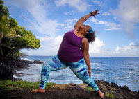 Yoga woman doing Reverse Warrior in Hawaii