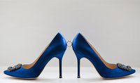 Stunning side on view of these something blue  Manolo Blahnik wedding shoes with engagement ring balancing between the shoes. Captured by Nicci at Adorlee