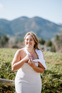 woman smiles during boulder photo session