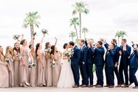 Wedding at Arizona Grand Resort and Spa Bride kissing Groom with bridal party cheering