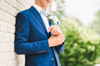 groom leaning up against a wall for portraits at a Cincinnati Ohio wedding