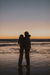 couple watches sun go down