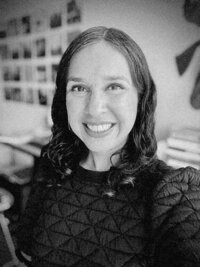 Close-up black and white image of woman in a room