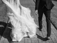 Bride and groom walking on brick path by baltimore wedding photographer Nicole Simensky