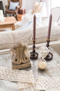 Antique candlesticks and accessories on a coffee table