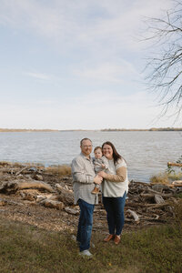 family posing at waterfront park during RVA family photographer's photo session