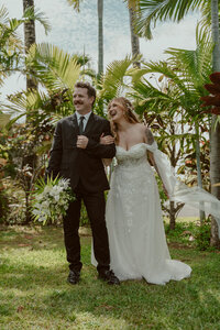Hawaii Elopement Photographer- couple celebrating their hawaii elopement with a glass of champagne