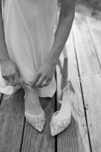 Bride puts on her Bella Belle shoes during her Cape Cod wedding.