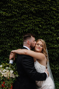A person kissing their partner's cheek