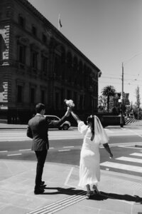Modern bride and groom walk through inner city streets of melbourne
