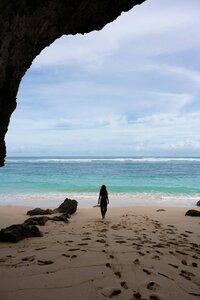 woman walking on sandy beach
