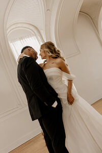 "Bride and groom celebrate their elegant luxury wedding at the historic Cottonwood Hotel in Omaha, NE – timeless moments captured by Tori Nichole Photography. A perfect blend of sophistication, romance, and architectural charm, showcasing the couple's love story in an unforgettable setting.