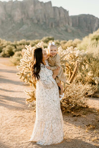 mom holding daughter