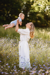 Mother flies her baby in the air during Family Photoshoot in Charleston, SC.