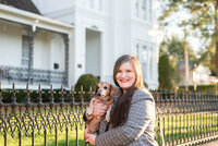 Lauren holds her mini dachshund outdoors