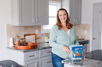 Woman smiling while organizing home supplies
