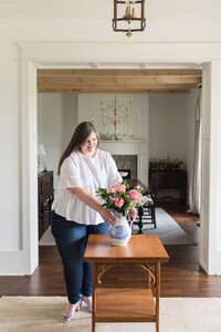 Lauren arranges pink roses in blue and white vase