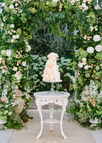 Wedding Cake under floral arch