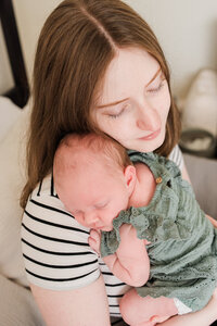 Mom and baby sweet moment in home newborn photo session
