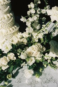 cake and florals displayed on the reception table captured on 35mm film at an Austin texas wedding venue
