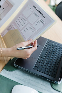 Close-up of a Liv Med Spa specialist in Sioux Falls reviewing medical weight loss progress on a clipboard with charts.