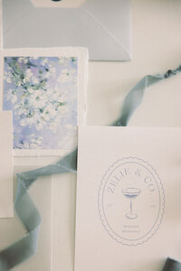 White and blue wedding stationary flat lay with ribbon