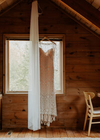 Dress hangs before bride gets ready for her Duluth, Minnesota wedding