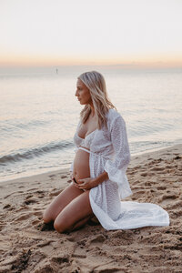 pregnant woman at the beach at sunset