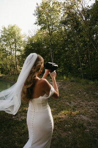bride taking candid nature photography, Super 8 wedding film, bride in white wedding dress