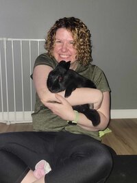Amanda smiling while holding her rabbit