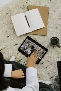 Kemotion team member designing a website on a tablet, focused on custom web design for service-based businesses.