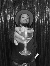 glam photo booth image in black and white of a man holding a glass at a wedding