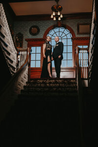 newlyweds at top of staircase
