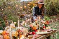 Lady fixing the fall-inspired tablescape