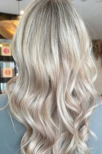 Soft blonde waves with luminous highlights, styled expertly at Blake & Kwan Hair Salon in Sydney, showcasing premium hair services.