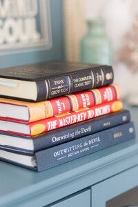 A stack of books from Napolean Hill