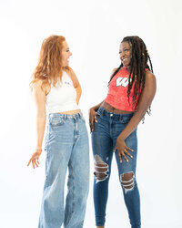 two models wearing college game day cropped tank tops with jeans