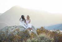 Colorado couple in beuna vista laughing on a rock