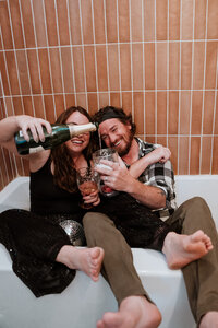 Couple partying in a bathtub with champagne and a disco ball in Breckenridge, Colorado.
